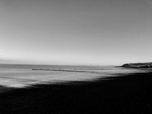 sea waves rolling on sandy shore in daylight